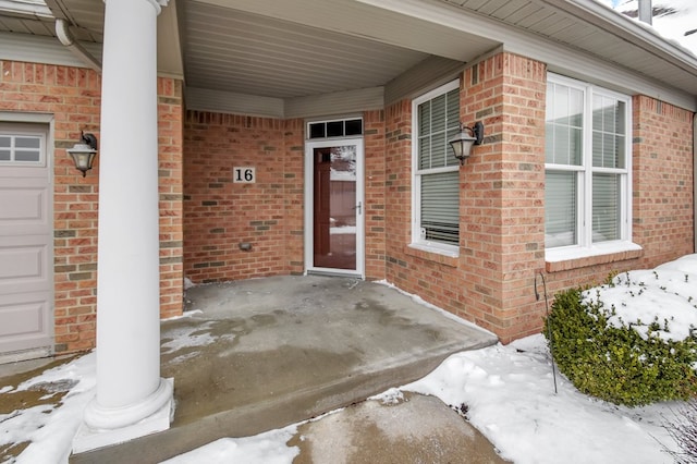 view of snow covered property entrance