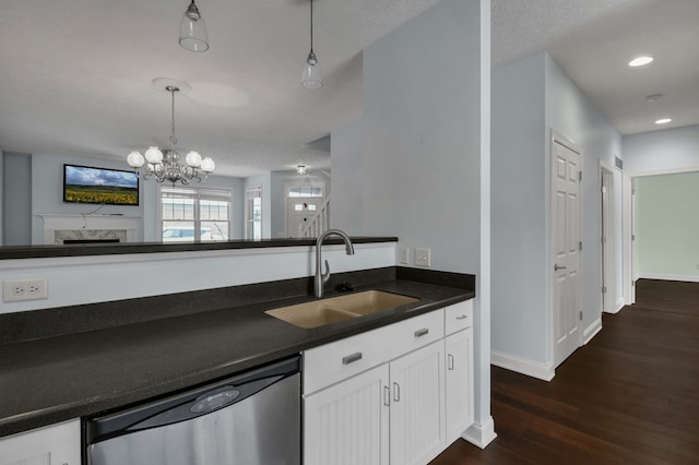 kitchen with dishwasher, sink, a chandelier, pendant lighting, and white cabinets