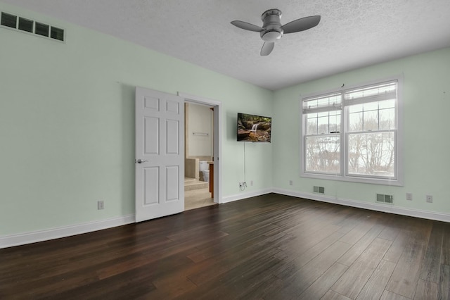 unfurnished room featuring ceiling fan, dark hardwood / wood-style flooring, and a textured ceiling