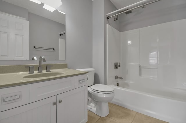 full bathroom featuring shower / washtub combination, tile patterned flooring, vanity, and toilet