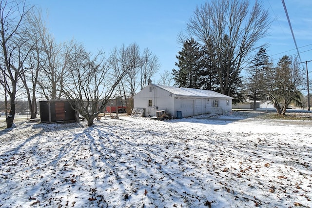 view of snow covered back of property