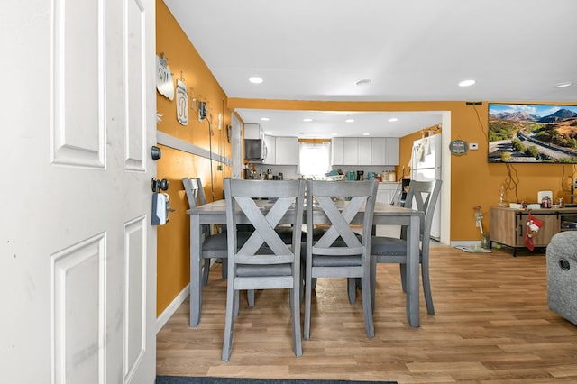 dining space with light wood-type flooring