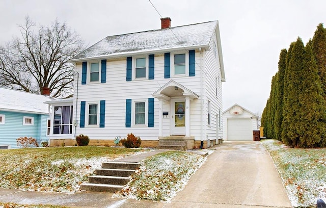 colonial-style house with a garage and an outdoor structure