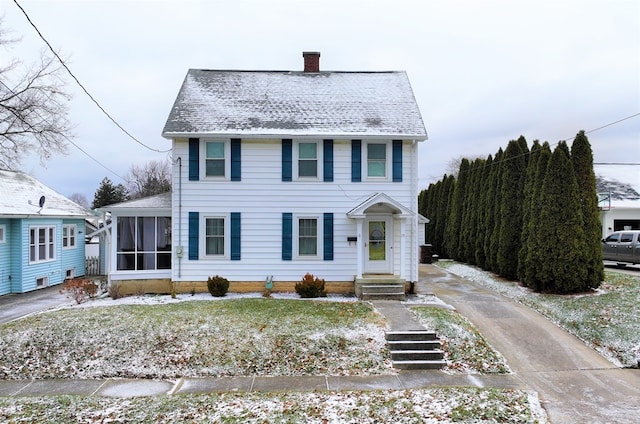 view of front of house featuring a sunroom