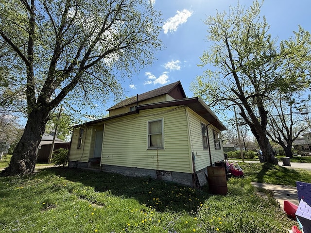 view of home's exterior with a lawn