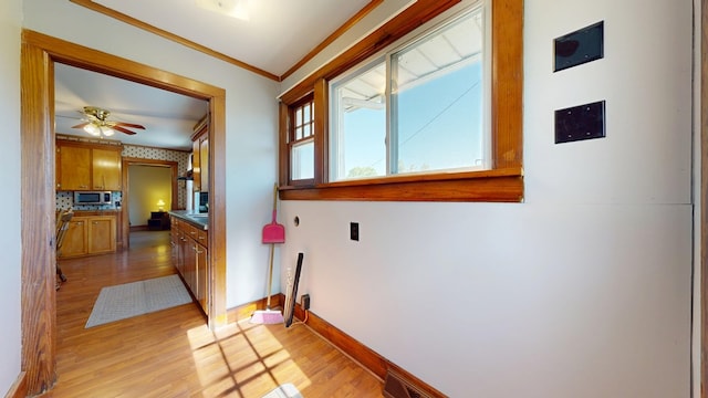 531 Jackson Rd, Galion, OH 44833 - hallway featuring light wood finished floors, crown molding, and baseboards