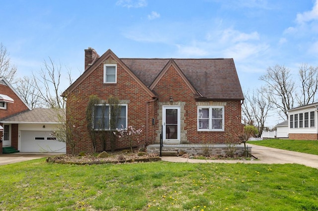 501 Clifton Blvd, Mansfield, OH 44907 - tudor-style house with brick siding, a chimney, a front lawn, and a garage