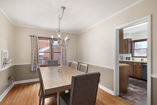 501 Clifton Blvd, Mansfield, OH 44907 - dining space with a chandelier, dark wood finished floors, baseboards, and crown molding