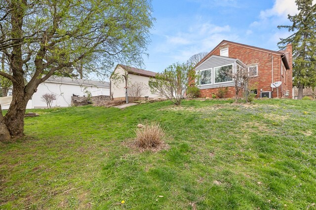 501 Clifton Blvd, Mansfield, OH 44907 - rear view of house featuring brick siding, a yard, and a chimney