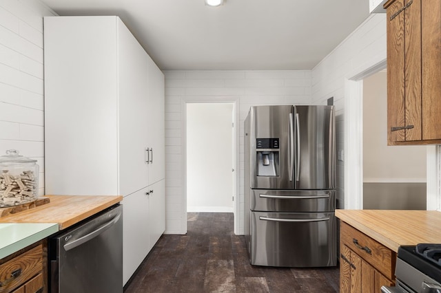 501 Clifton Blvd, Mansfield, OH 44907 - kitchen featuring appliances with stainless steel finishes, brown cabinetry, butcher block countertops, and dark wood-style flooring