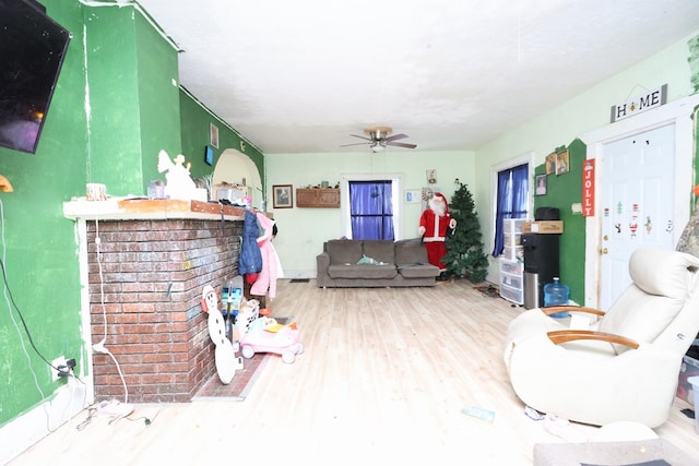 living room with ceiling fan and light hardwood / wood-style flooring