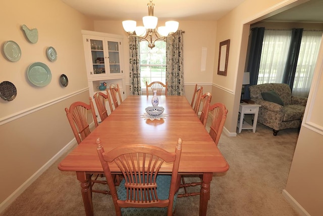 10411 River Rd, Huron, OH 44839 - dining space with a chandelier and light colored carpet