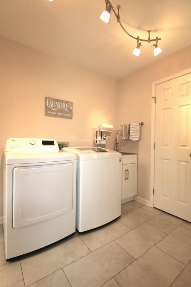 10411 River Rd, Huron, OH 44839 - washroom with cabinet space, separate washer and dryer, and light tile patterned floors