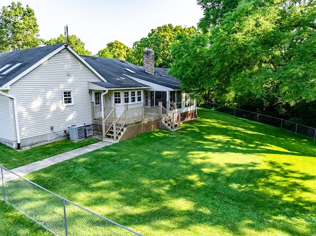 10411 River Rd, Huron, OH 44839 - rear view of house featuring a fenced backyard, a shingled roof, and a chimney