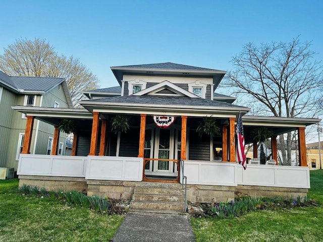 view of front of property featuring a shingled roof and covered porch
