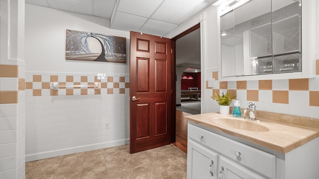 1439 Township Rd Unit 1238, Ashland, OH 44805 - bathroom featuring tile walls, vanity, a paneled ceiling, and a wainscoted wall