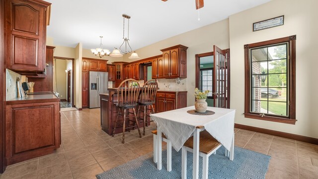 1439 Township Rd Unit 1238, Ashland, OH 44805 - dining room featuring light tile patterned flooring, a chandelier, ceiling fan, and baseboards