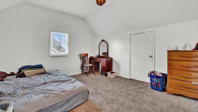 carpeted bedroom featuring ceiling fan and vaulted ceiling