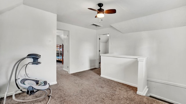 additional living space featuring carpet floors, vaulted ceiling, and ceiling fan