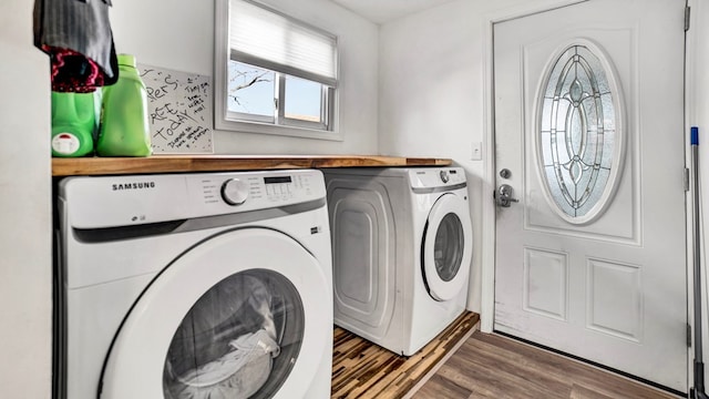 laundry area with washing machine and dryer and dark wood-type flooring