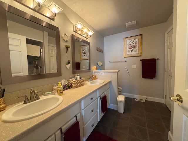 bathroom with tile patterned floors, vanity, and toilet