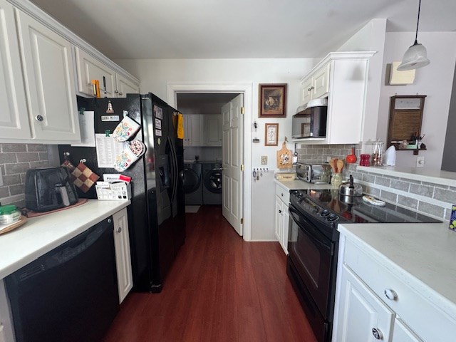 kitchen featuring hanging light fixtures, white cabinets, independent washer and dryer, and black appliances