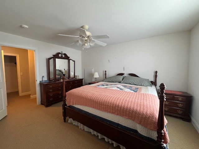 carpeted bedroom with ceiling fan