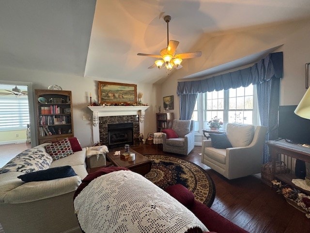 living room with lofted ceiling, dark hardwood / wood-style floors, and ceiling fan