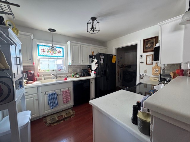 kitchen with sink, white cabinetry, tasteful backsplash, pendant lighting, and black appliances