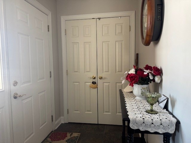 doorway featuring dark tile patterned flooring