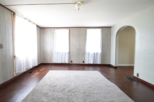 unfurnished room with dark wood-type flooring