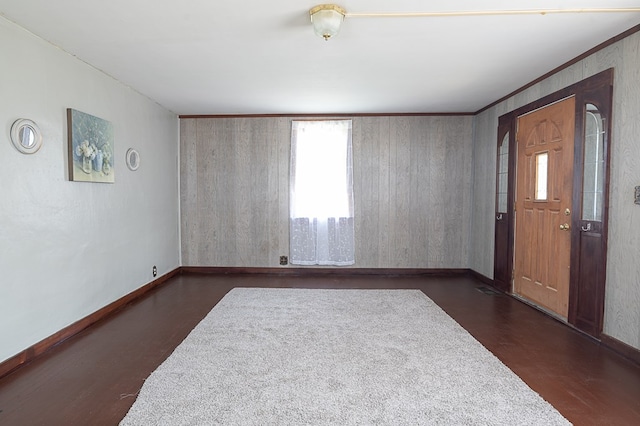 unfurnished room featuring crown molding and dark wood-type flooring