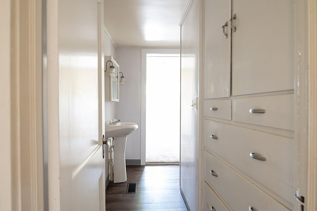 interior space with hardwood / wood-style floors and sink