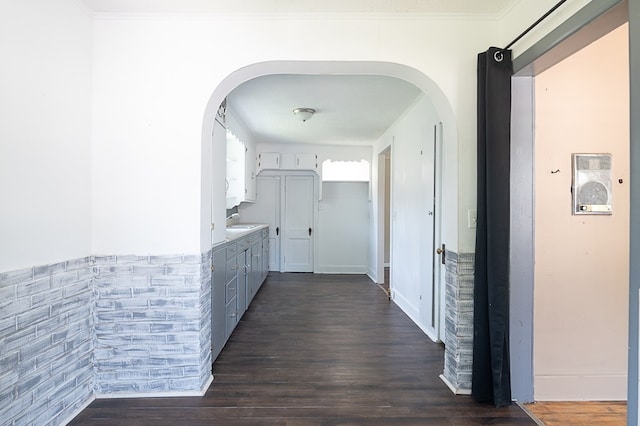 corridor featuring dark hardwood / wood-style floors and crown molding