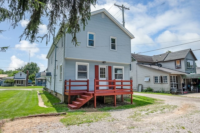 back of house with a yard and a wooden deck