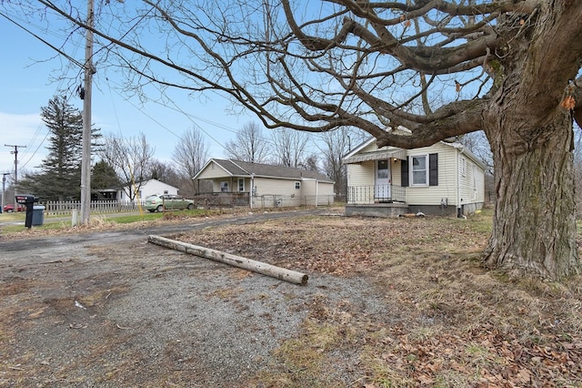 bungalow-style home featuring fence