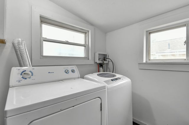 laundry area with laundry area, separate washer and dryer, and a wealth of natural light