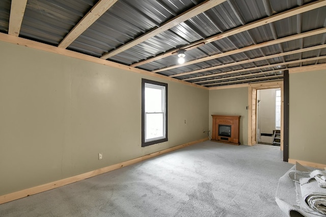 unfurnished living room featuring carpet flooring and a fireplace