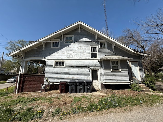 rear view of property with entry steps
