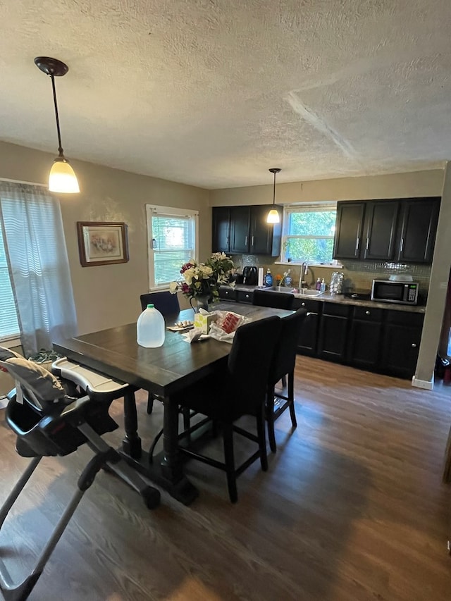 148 Dale Ave, Mansfield, OH 44902 - dining area featuring a textured ceiling, wood finished floors, and healthy amount of natural light