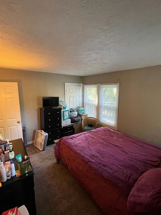 carpeted bedroom featuring a textured ceiling