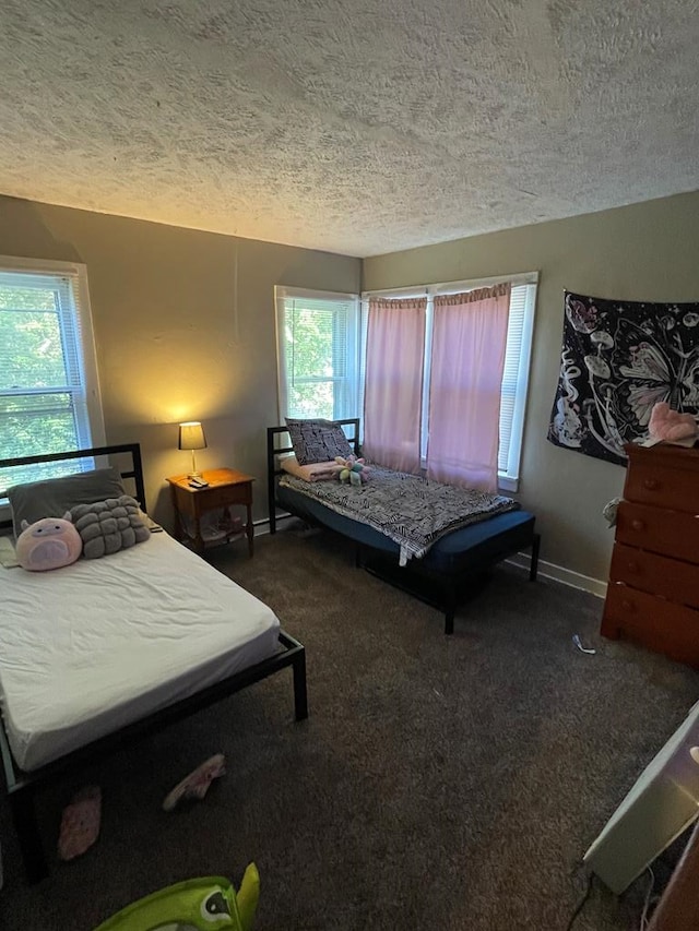 carpeted bedroom featuring a textured ceiling