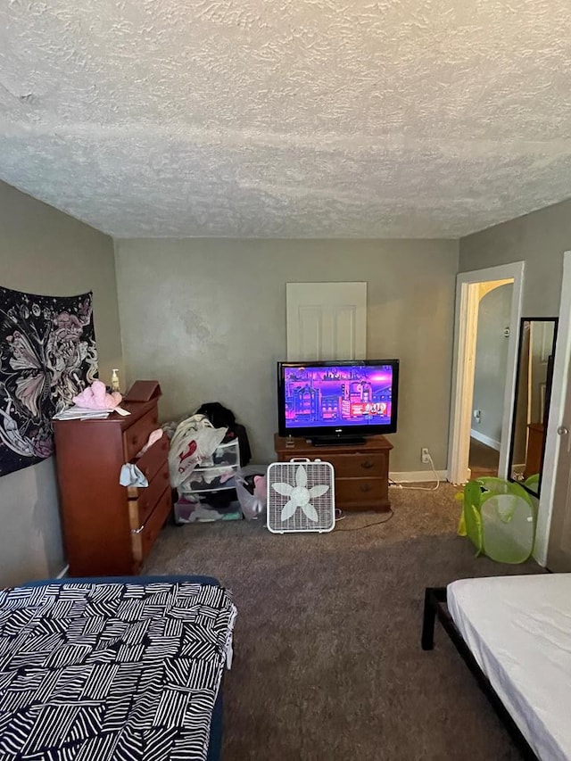 carpeted bedroom featuring a textured ceiling