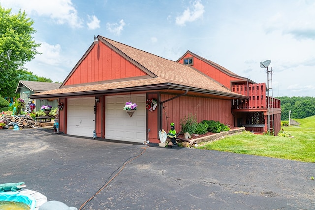 7326 State Route 19 Unit 47-48, Mount Gilead, OH 43338 - view of side of home featuring a shingled roof, a yard, a wooden deck, and a garage