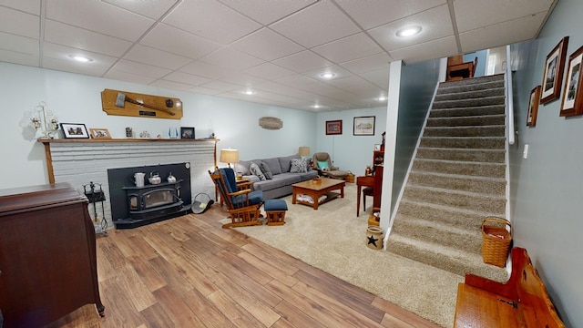 living room featuring light wood-type flooring and a wood stove