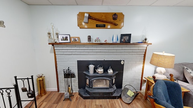 details with hardwood / wood-style flooring and a wood stove