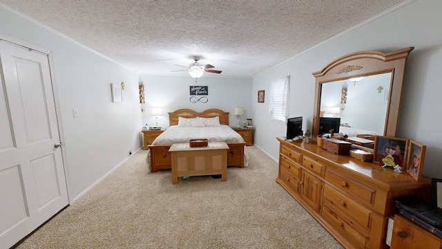 bedroom featuring ceiling fan, light colored carpet, a textured ceiling, and crown molding