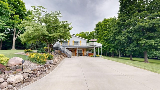 farmhouse with a front yard and a deck