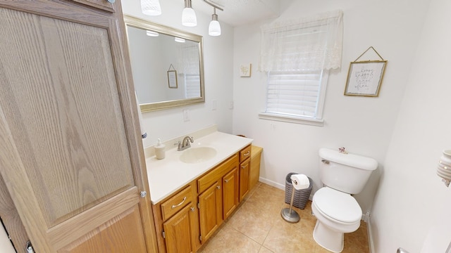 bathroom featuring vanity, toilet, and tile patterned floors