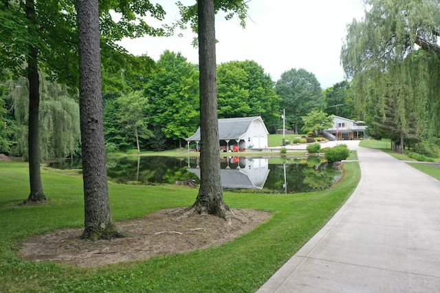 view of property's community featuring a water view and a yard